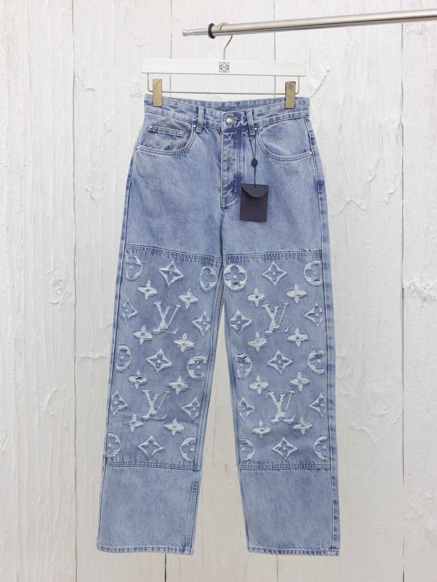 Lightly distressed denim trousers