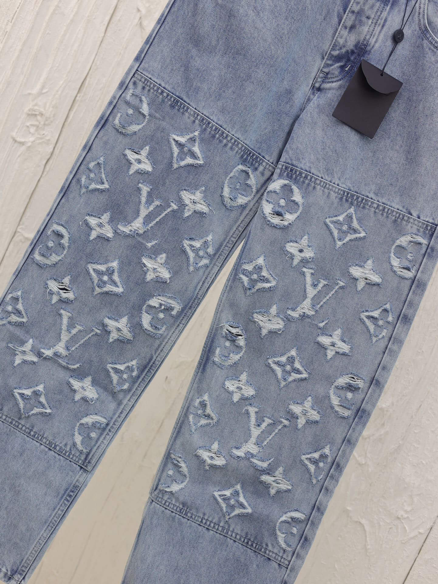 Lightly distressed denim trousers